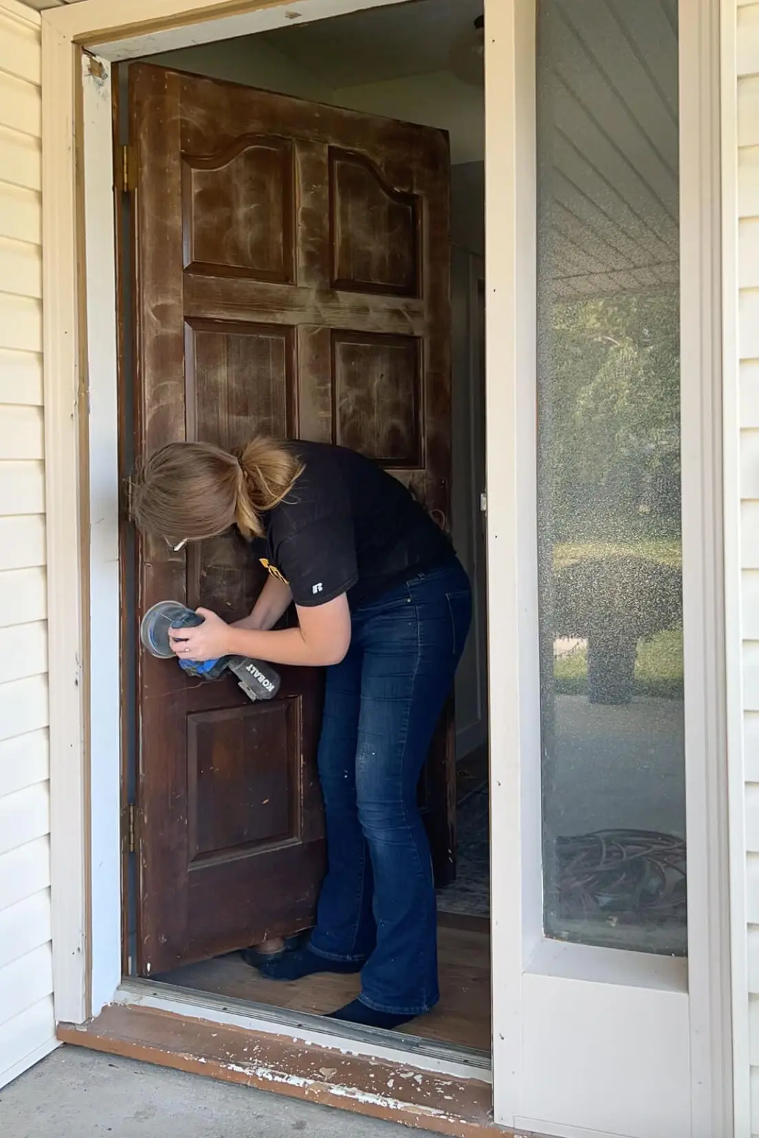 Sanding old, wood door to get it ready to paint.